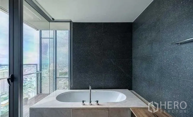 Condominium for rent - Soaking tub by the window with dramatic city views.