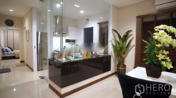 Detached House for rent or sale in Bang Phli, Samut Prakan - Glass-enclosed modern kitchen with stainless range hood beside the dining area.