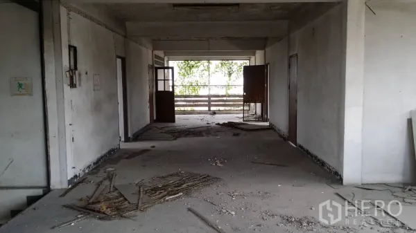 Office Space for rent in Don Mueang, Bangkok - Long corridor on a vacant office floor with multiple doors and an open balcony area, ideal for renovation.