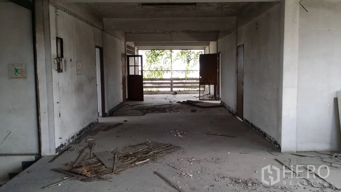 Office Space for rent in Don Mueang, Bangkok - Long corridor on a vacant office floor with multiple doors and an open balcony area, ideal for renovation.