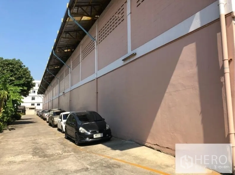 คลังสินค้า ให้เช่าในSam Phran, Nakhon Pathom - มุมด้านข้างอาคาร มีชายคาคลุม พื้นคอนกรีต และช่องจอดรถเป็นแถว