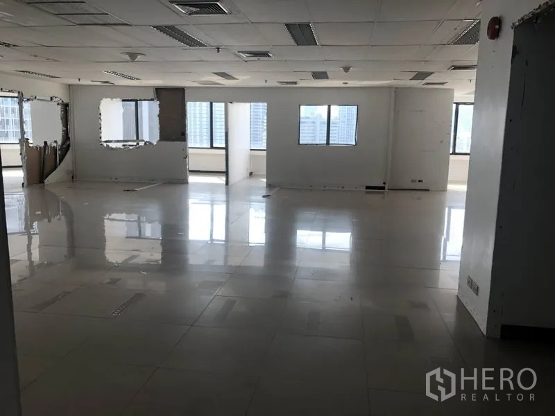 办公空间 出租在Watthana, Bangkok - 宽敞开放式办公室，格栅吊顶灯具，窗外城市景观