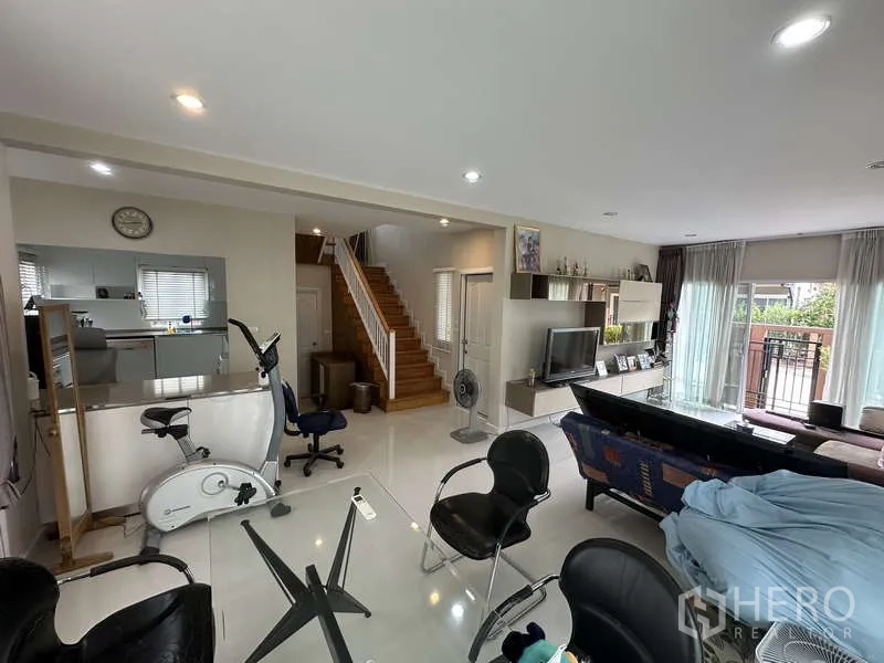Detached House for sale in Sai Mai, Bangkok - Open-plan living and dining area with stairs leading to the kitchen.