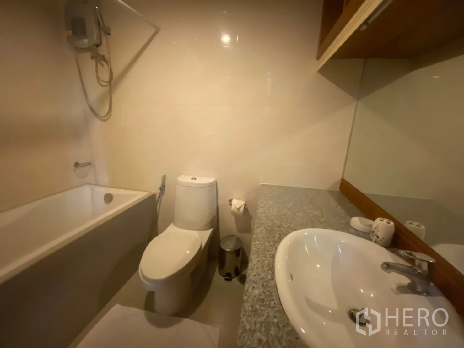 Condominium for rent in Phaya Thai, Bangkok - Bathroom featuring a bathtub, handheld shower, vanity, and large mirror.