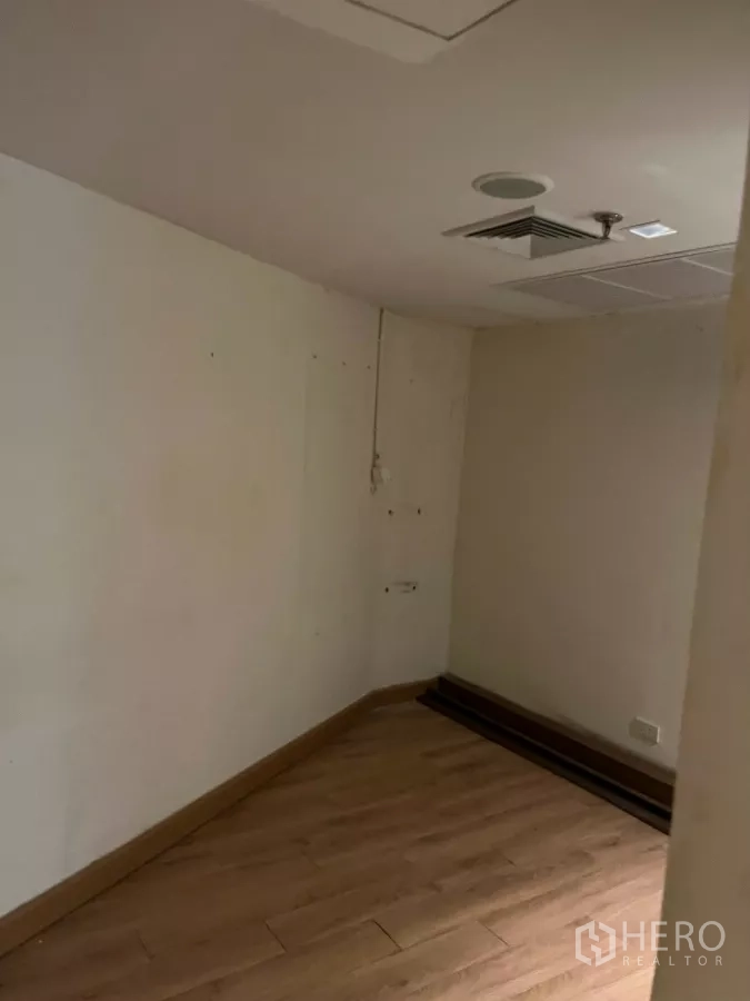 Office Space for rent - Small office with wood floors, ceiling vents and recessed lighting.