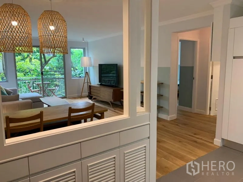 Condominium for sale in Watthana, Bangkok - Kitchen pass-through window framing the dining and living space.