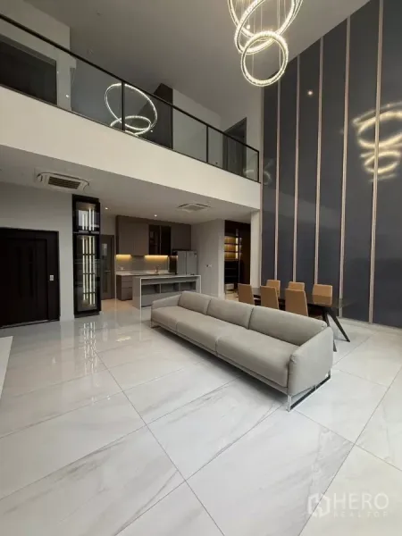 Detached House for rent in Saphan Sung, Bangkok - Double-height living and dining area with glass balustrade and statement ring chandeliers.