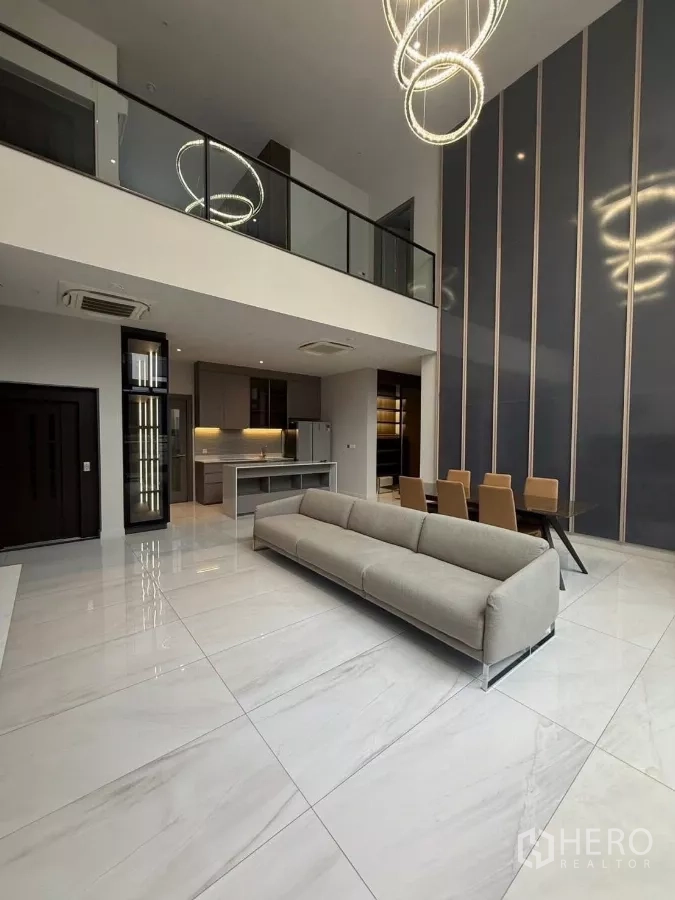 Detached House for rent in Saphan Sung, Bangkok - Double-height living and dining area with glass balustrade and statement ring chandeliers.