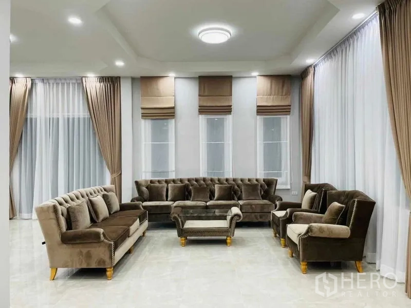 Warehouse for rent or sale in Pathum Thani - Elegant living area with velvet sofas, coffee table and soft lighting.