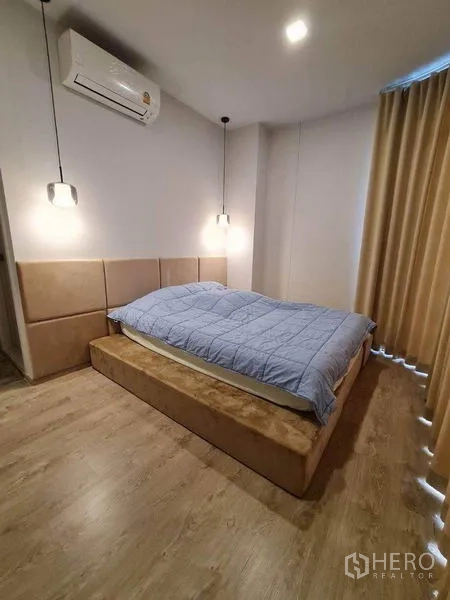 Condominium for rent - Primary bedroom with platform bed, pendant bedside lights, air conditioning and blackout curtains.