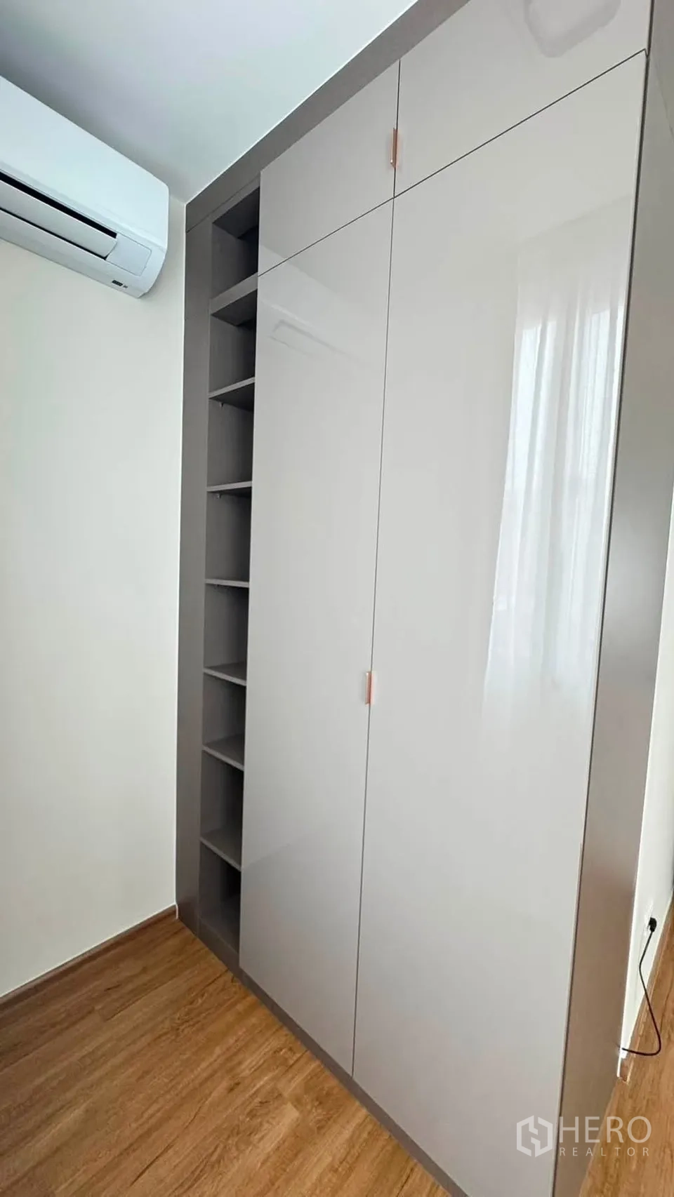 联排别墅 for rent in Bang Phli, Samut Prakan - 内置高光衣柜与开放格架，旁有空调机。