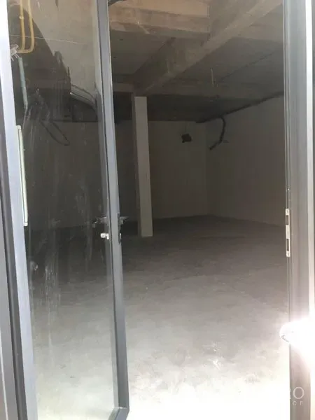 Office Space for rent in Khlong Toei, Bangkok - Unfinished open-plan office interior with concrete floor, exposed ceiling, structural column and glass door entry near BTS Phra Khanong.