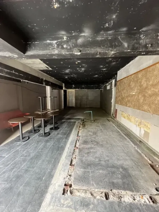 Retail Space for rent in Watthana, Bangkok - Long open-plan retail space with black ceiling, trenching in the floor and a few small pedestal tables.