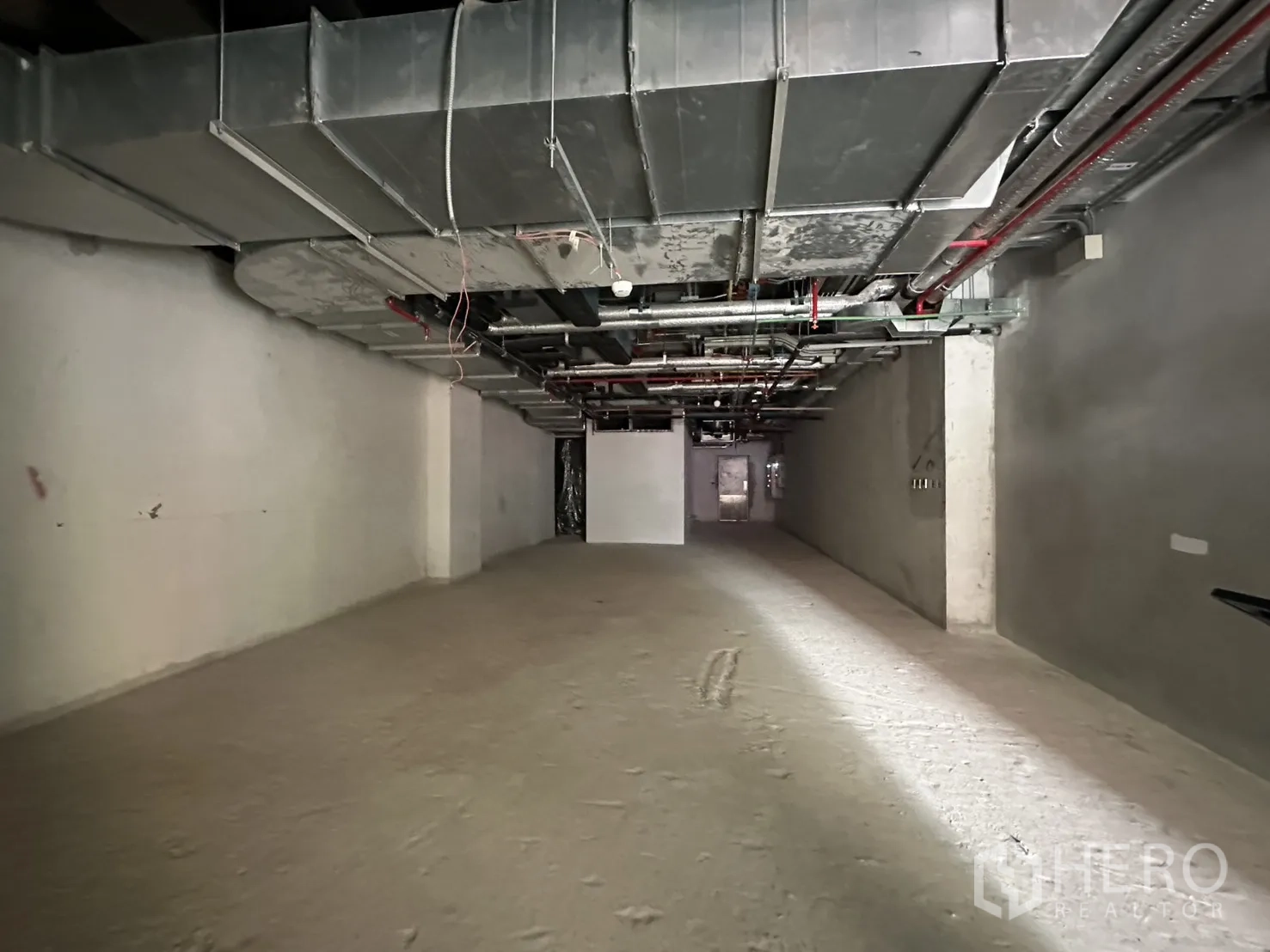 Retail Space for rent in Bang Rak, Bangkok - Deep rectangular retail interior with unfinished walls, ducting, and visible piping.