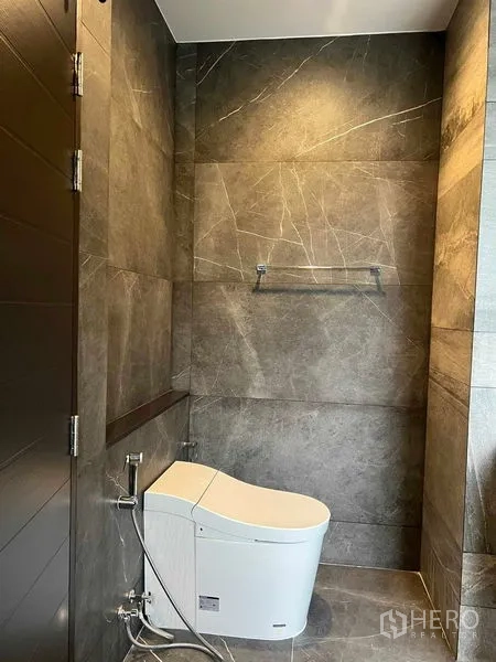 Detached House for sale in Bang Kruai, Nonthaburi - Guest bathroom with gray marble-look tiles and smart toilet.