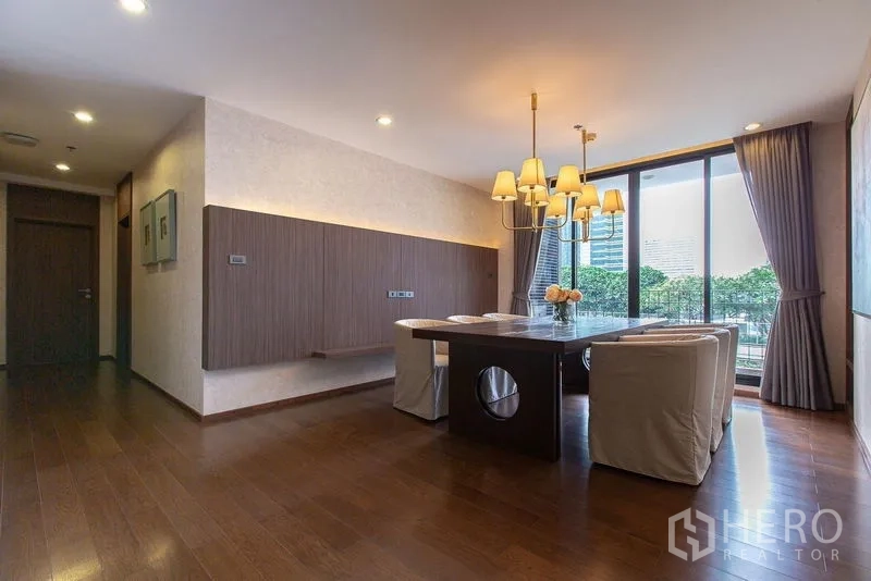 Condominium for rent or sale - Dining room with chandelier, large windows and balcony-style sliding doors.