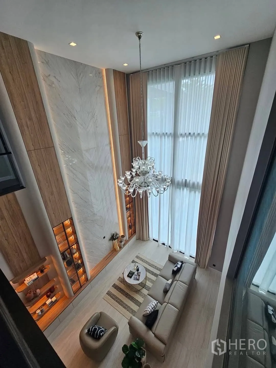独栋房屋 for rent or sale in Suan Luang, Bangkok - 俯视双层挑高客厅，吊灯与大窗。