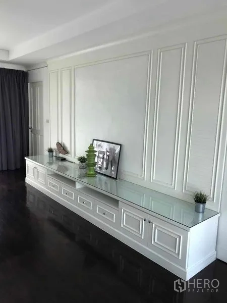 Detached House for sale in Wang Thonglang, Bangkok - Long white built-in media console with glass top and decorative wall panels