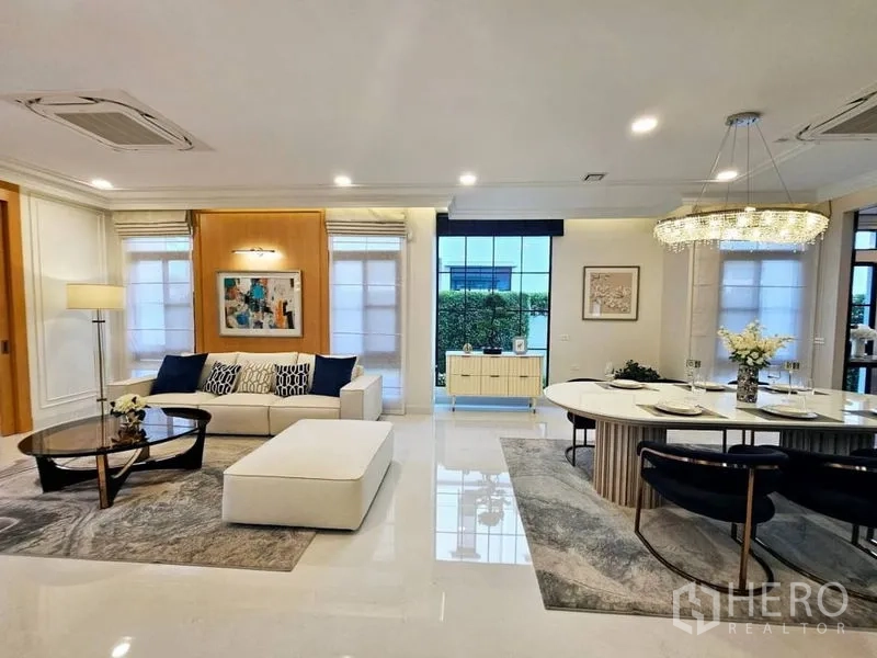 Detached House for rent or sale in Saphan Sung, Bangkok - Open‑plan living and dining space with glossy floors and wide windows.