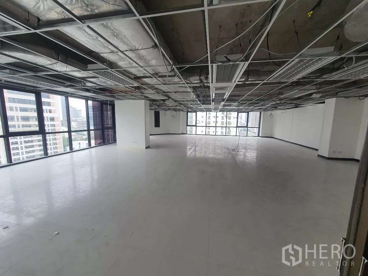 Office Space for rent in Bang Rak, Bangkok - Open‑plan 15th‑floor office with exposed ceiling grid, vinyl flooring and city views.
