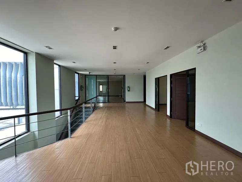 Warehouse for rent in Prawet, Bangkok - Upper-floor corridor with railing, windows, and private office doors.