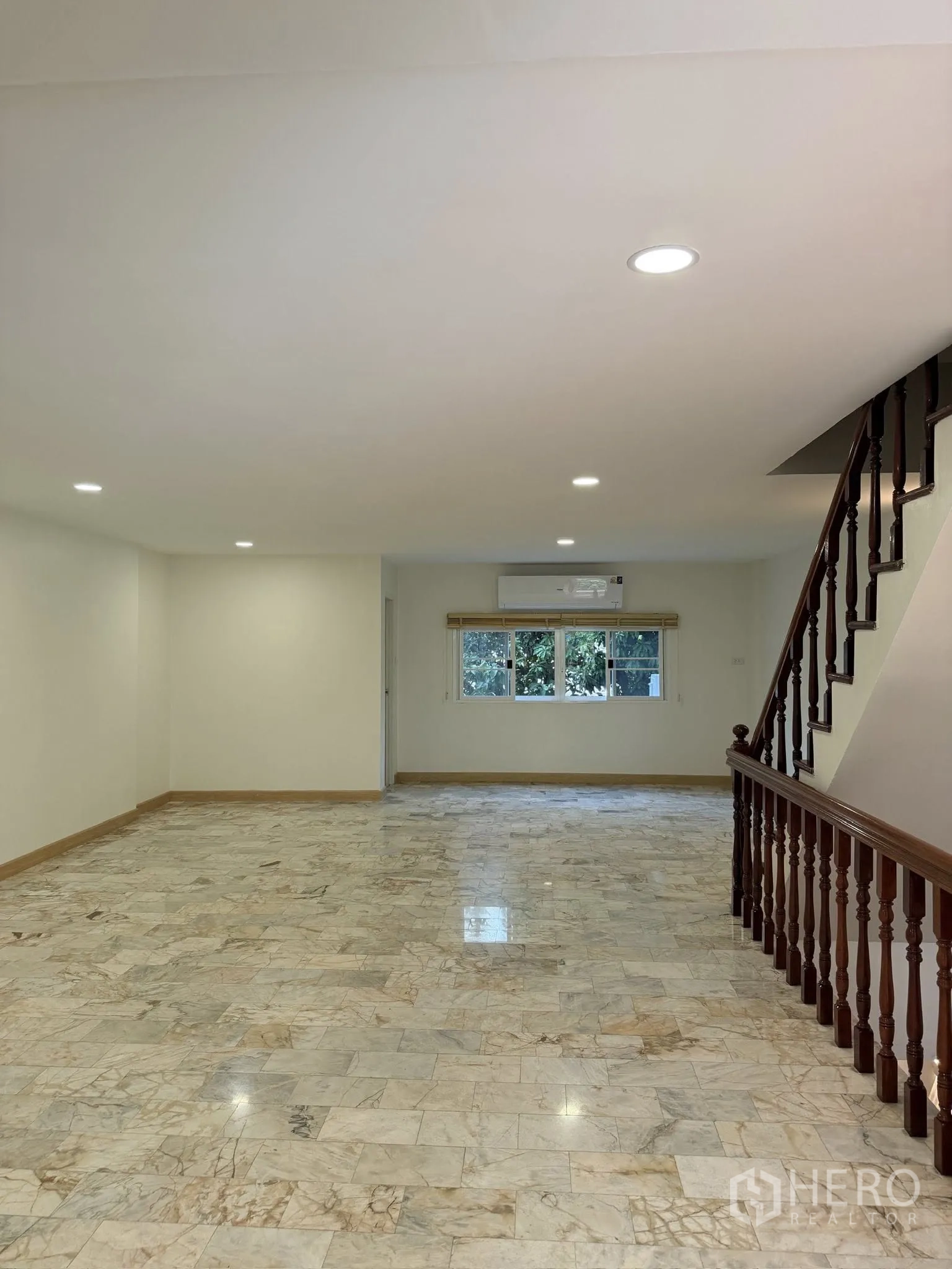 Townhouse for rent or sale in Yan Nawa, Bangkok - Long living space with recessed lighting and window at far end.