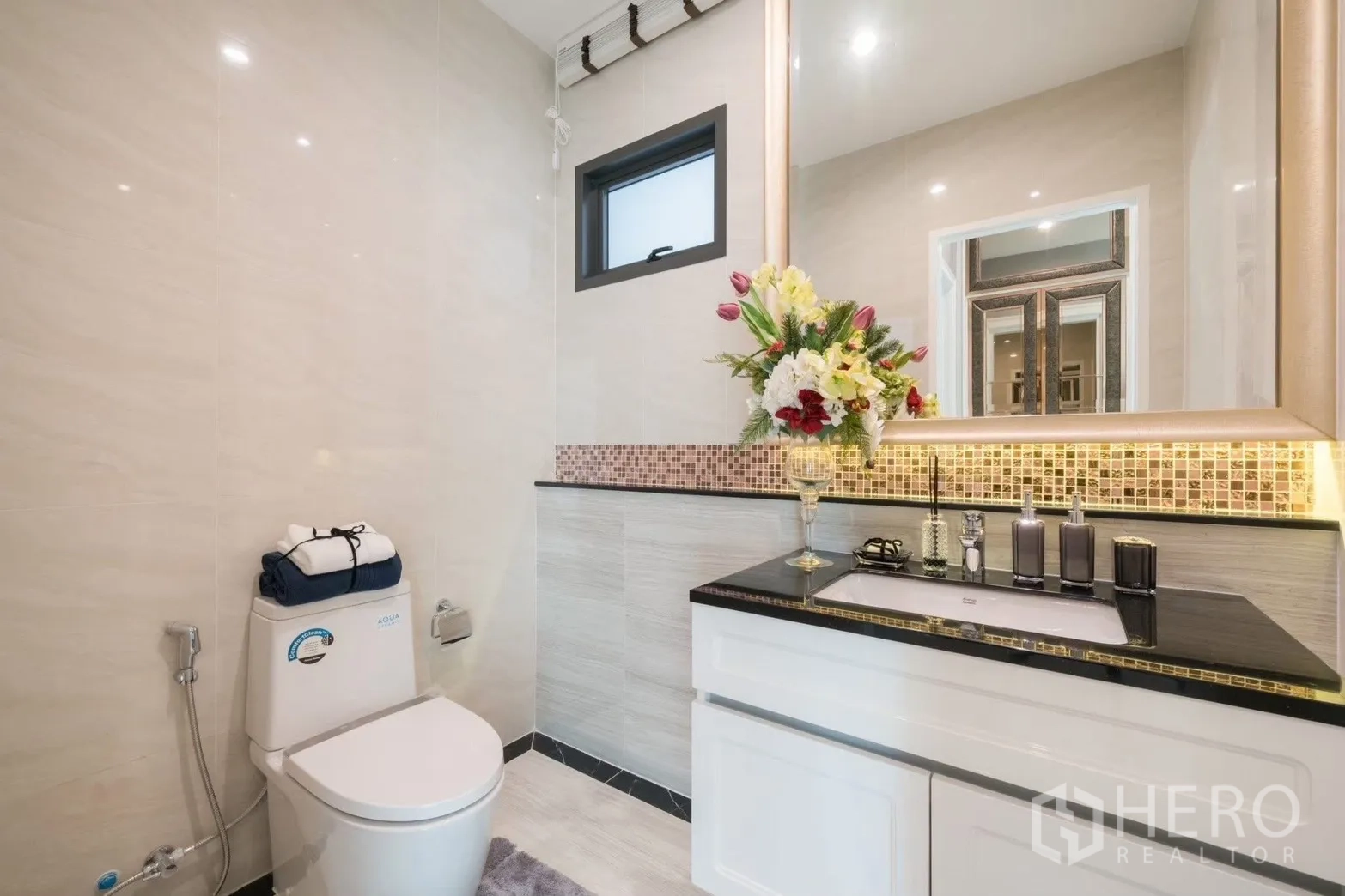 Detached House for rent in Prawet, Bangkok - Guest bathroom with framed mirror, mosaic backsplash and stone countertop vanity