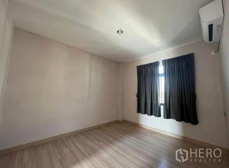 Townhouse for rent or sale in Bang Kho Laem, Bangkok - Bedroom with window, blackout curtains and wall-mounted air conditioner.