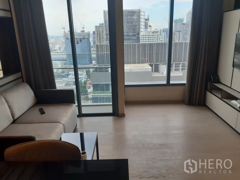 公寓 出租或出售在Watthana, Bangkok - 客厅采光充足，落地窗俯瞰曼谷天际线。