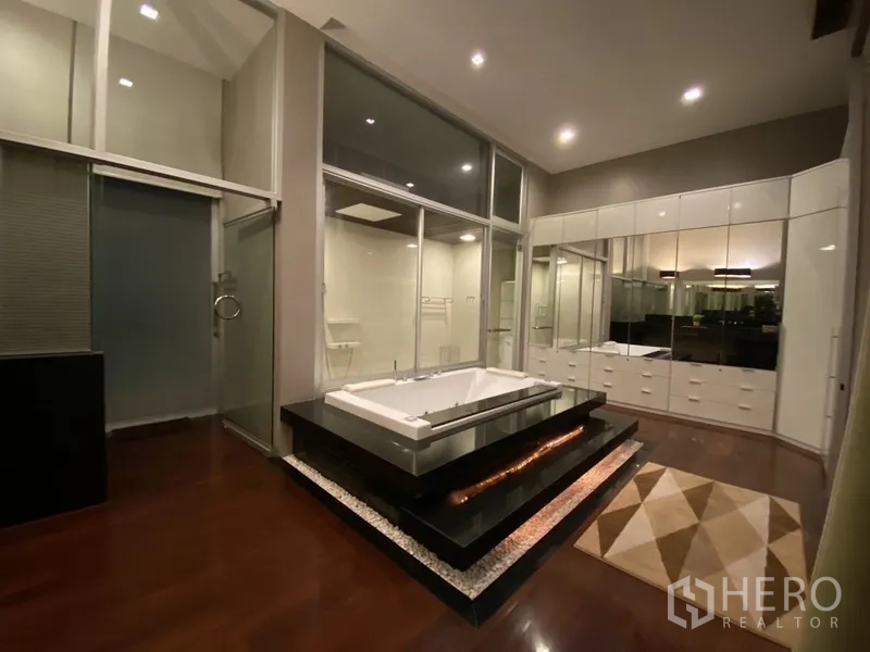 Townhouse for rent or sale in Chatuchak, Bangkok - Luxury bathroom with raised soaking tub, wood floors and glass partitions.