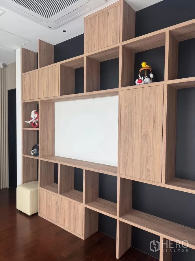 Detached House for rent in Lat Krabang, Bangkok - Custom wooden shelving unit providing display and storage along a feature wall.