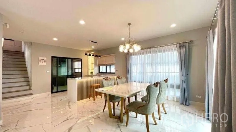 Detached House for rent or sale in Bang Phli, Samut Prakan - Dining area beside floor-to-ceiling curtains and bright kitchen.