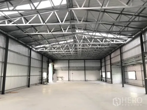 货栈 出租在Don Mueang, Bangkok - 仓库内部，高挑钢桁架屋顶与光滑混凝土地面，采光充足。