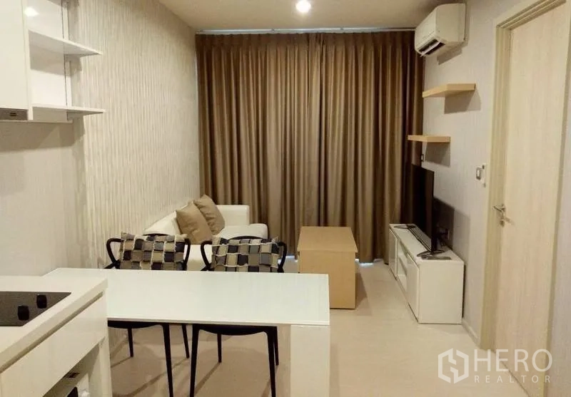 Condominium for rent in Khlong Toei, Bangkok - Modern living room with sofa, TV console, dining table and full-length curtains in a compact Bangkok condo.