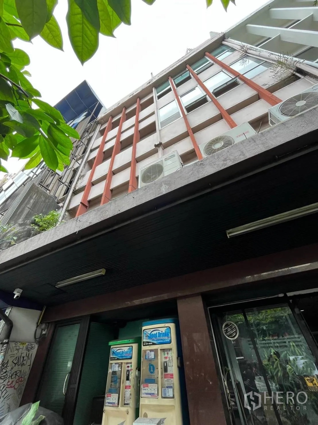 Shophouse for rent in Khlong Toei, Bangkok - Multi-storey building facade with vertical fins and exterior air-conditioning units.