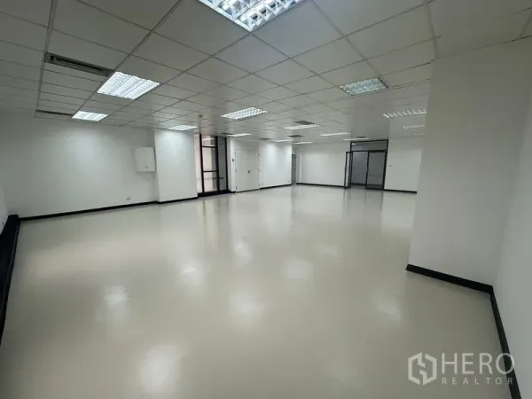 Office Space for rent - Angle view of open office showing glass entry and partition, smooth floors and recessed lighting.