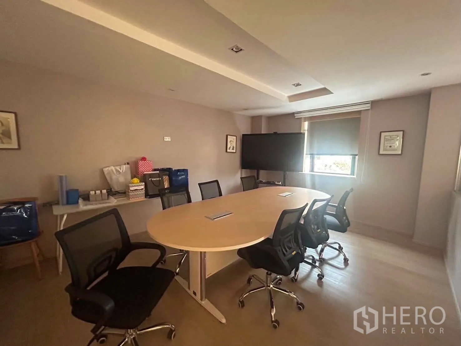 Office Space for rent in Bang Rak, Bangkok - Conference room with oval table, mesh chairs, flatscreen and window blind