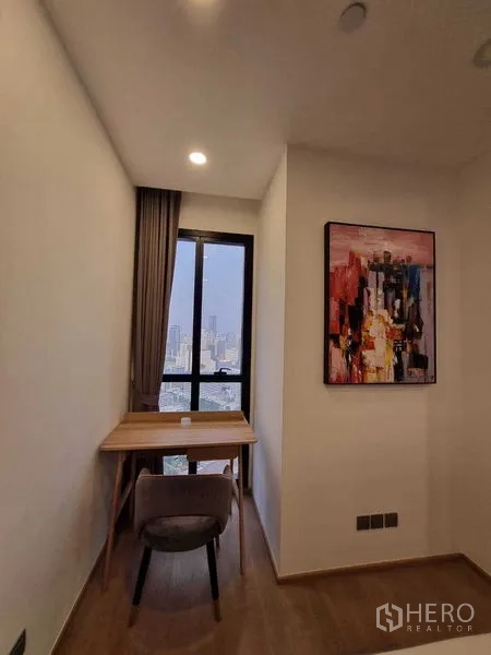Condominium for rent in Bang Rak, Bangkok - Work nook with wooden desk by the window offering skyline views.