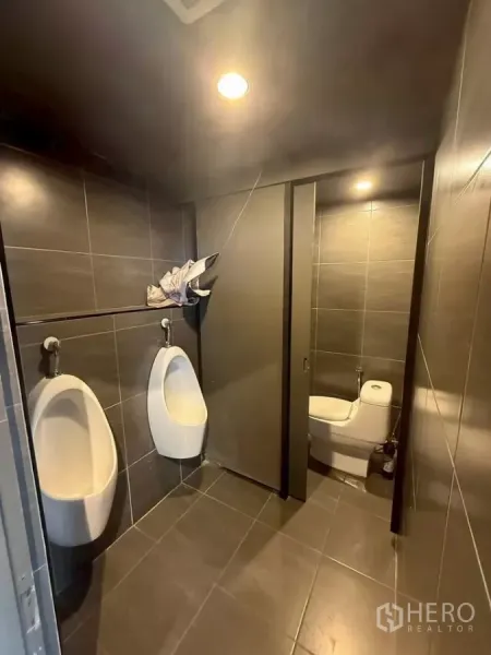 Retail Space for rent in Watthana, Bangkok - Modern tiled restroom featuring urinals and a private toilet cubicle.