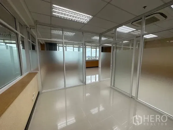 Office Space for rent in Suan Luang, Bangkok - Corridor-style area with multiple frosted glass doors and natural light from perimeter windows.