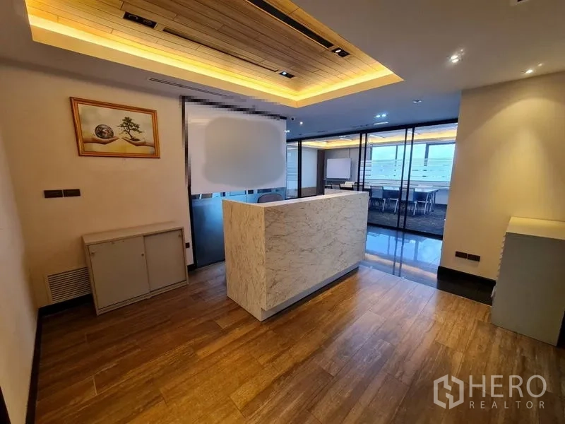 Office Space for rent - Welcoming reception with marble counter, warm wood ceiling and access to meeting rooms.