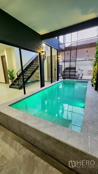 独立式住宅 出售在Khlong Toei, Bangkok - 抬高的瓷砖泳池，临车棚与竖向格栅遮挡。