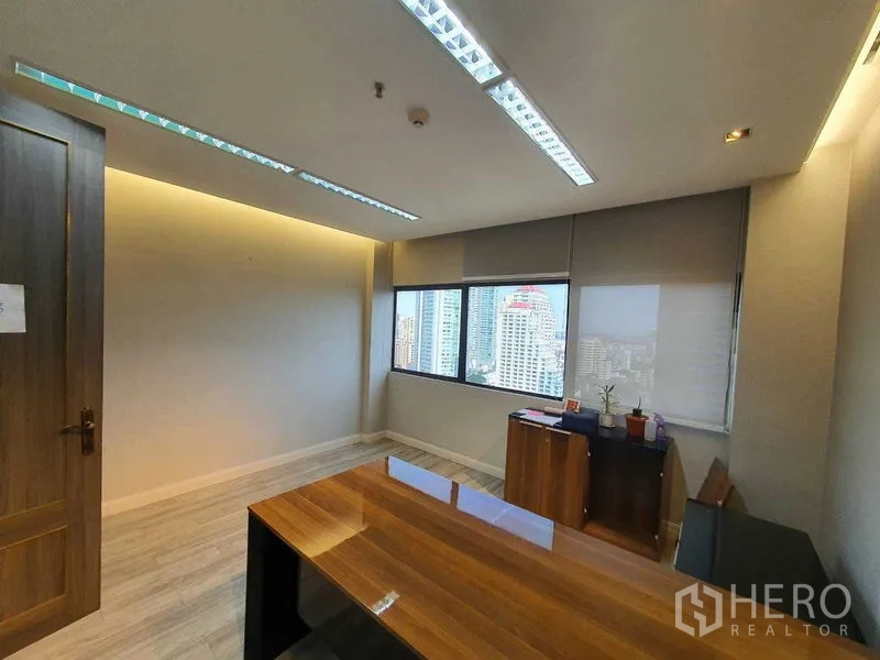 Office Space for rent in Watthana, Bangkok - Manager’s office with desk, windows and skyline outlook.