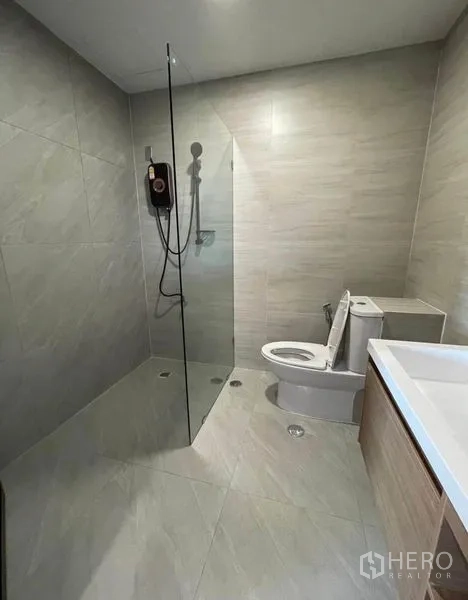 Condominium for rent - Contemporary bathroom with glass shower screen and rain shower.