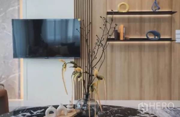 Detached House for rent in Bang Phli, Samut Prakan - Living room TV on feature wall with wood shelves and decorative vase.