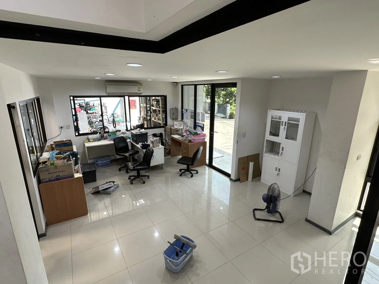 Factory for rent or sale in Pathum Thani - View from stairs into reception and office area with large windows.