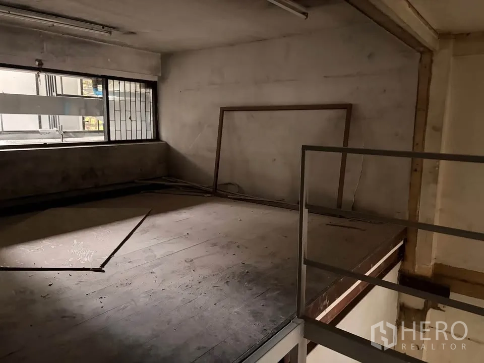 Retail Space for rent in Watthana, Bangkok - Empty mezzanine loft with window and low ceiling ready for custom fit-out.