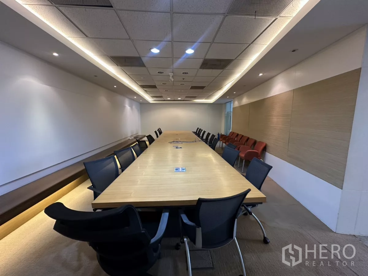Office Space for rent in Watthana, Bangkok - Long boardroom with a large wooden conference table and black chairs.