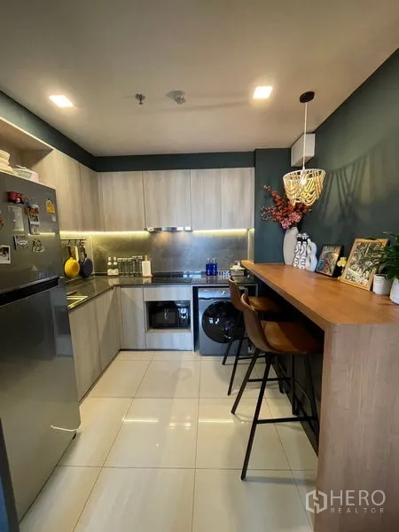 Condominium for sale - Kitchen with breakfast bar, pendant light and integrated appliances including oven and washer.