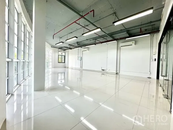 Office Space for rent in Khlong Toei, Bangkok - Open workspace with exposed ceiling, LED strip lights, and split air conditioners